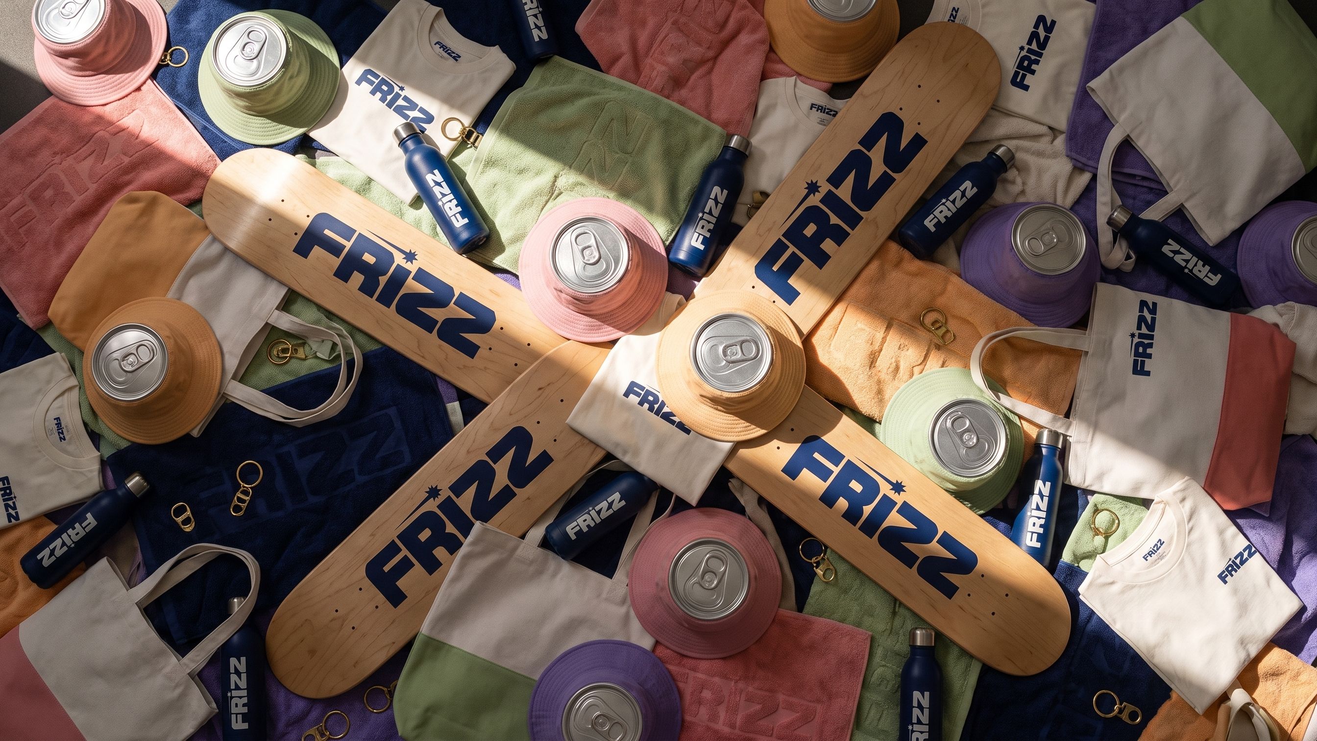 THE DROP: the Frizz merch laid out in hard sun, every piece cut from the can